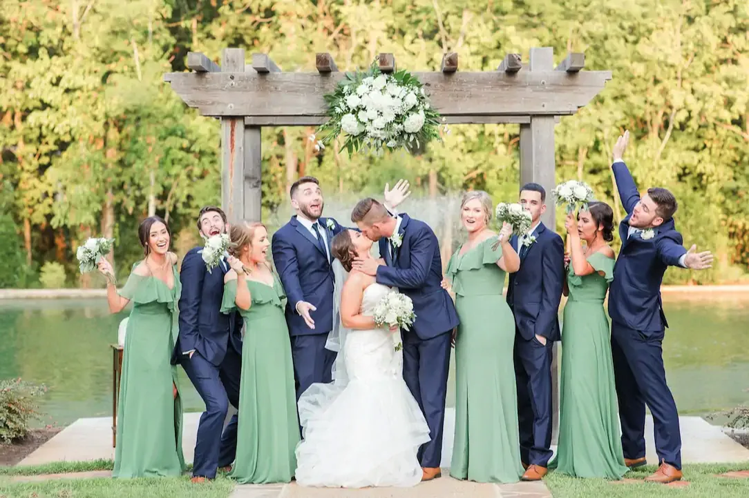 A Bayou Haven wedding party celebrating beside the pond